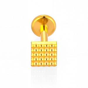 Macro detail of square gold titanium labret stud with textured grain surface and flat back