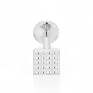 Macro detail of F136 titanium square flat back labret stud with micro-dot matrix texture