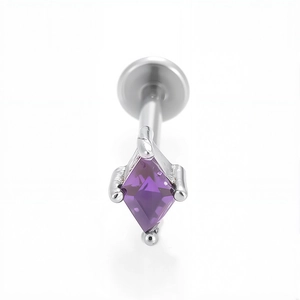 Dettaglio di un piercing labret in acciaio 316L con uno zircone viola a forma di aquilone