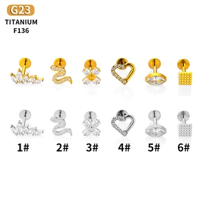 G23 Titanium lip and cartilage studs set with crown and snake designs in gold and silver