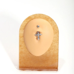 Cross-shaped zircon belly button ring made of stainless steel on a model display