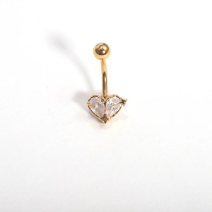 Detailed view of heart-shaped belly button ring with gold finish and zircon stones