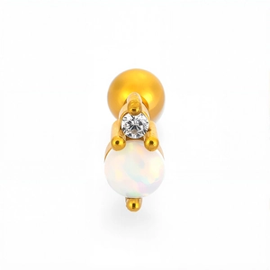 Macro detail of gold piercing stud with white opal and clear zircon on white background