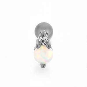 Detail view of steel tragus stud featuring round clear zircon and white opal stone inlay