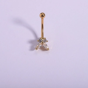 Macro detail of 316L gold plated navel ring with flower shaped sparkling zircons