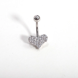 Detail shot of heart-shaped belly ring with sparkling zircon inlays on silver stainless steel