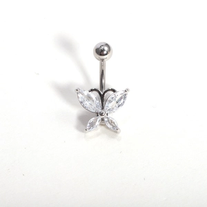 Detailed macro view of butterfly navel ring with zircon wings on polished steel