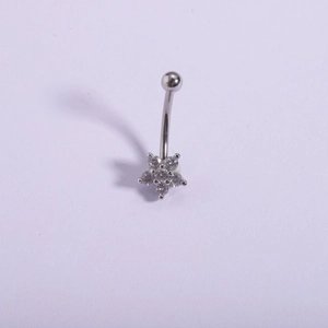 Macro shot of 316L stainless steel curved belly bar with clear zircon flower setting