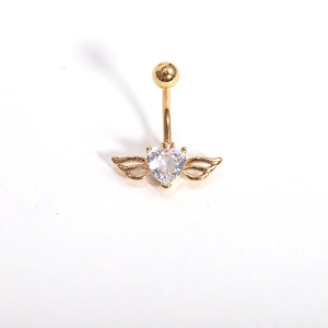 Macro view of golden navel ring featuring a heart-cut zircon and detailed angel wings