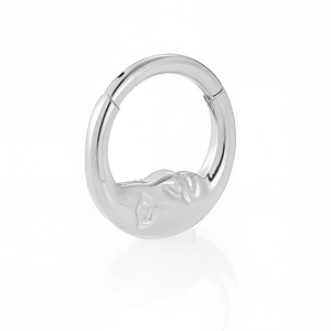Macro view of 316L stainless steel nose ring with embossed moon face design detail