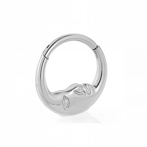Detail of 316L stainless steel nose ring featuring a unique closed-eye face relief design