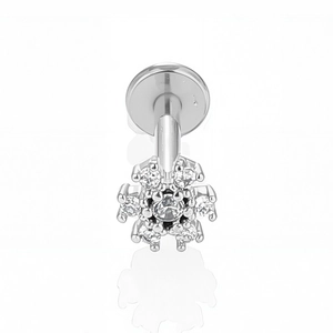 Macro detail of a 316L stainless steel flower labret stud with inlaid cubic zirconia crystals
