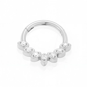 Macro detail of G23 titanium clicker ring featuring seven sparkling inlaid zircon stones