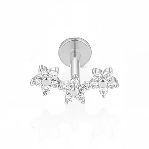 Close-up of triple flower labret stud with clear cubic zirconia in polished 316L steel