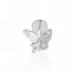 Détail macro du piercing papillon avec ailes en cristal et dos plat en acier inoxydable