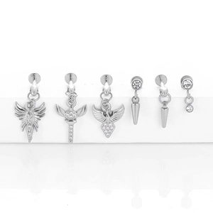 Close-up of 6-piece stainless steel piercing set with cone pendants and zircon accents
