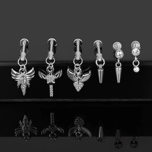 Detail of 316L stainless steel labret jewelry set with cone pendants and crystal wings