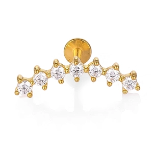Detail of gold-plated stainless steel curved labret stud featuring seven zircon stones