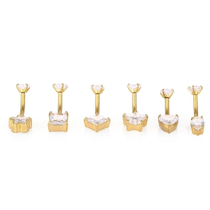 Macro detail of six 316L gold belly rings with different cubic zirconia shapes