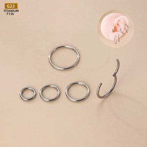 Detail of G23 titanium hinged clicker rings showing seamless opening and ear piercing fit