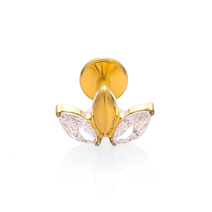 Macro detail of F136 titanium gold labret with three marquise-cut marquise gemstones