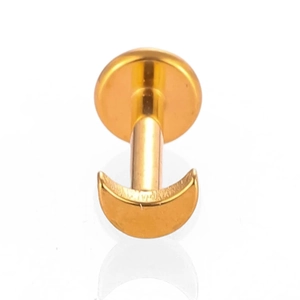 Detailed macro view of a polished gold moon shape titanium flat back labret stud piercing