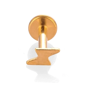 Macro shot of gold titanium labret stud featuring a polished lightning bolt design