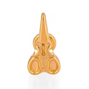 Macro view of gold scissor shaped labret stud earring with polished metal finish