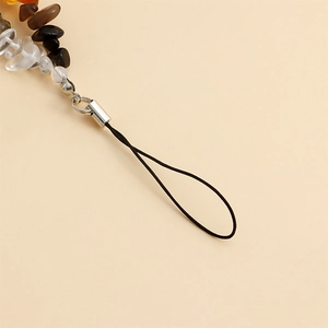 Detailed macro view of colorful natural gravel stones on a handmade phone strap chain
