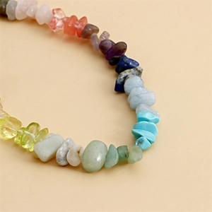 Macro shot of colorful natural stone beads with detailed textures on woven phone strap