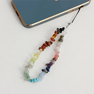Detail of colorful natural crushed turquoise stone phone strap handcrafted with steel wire