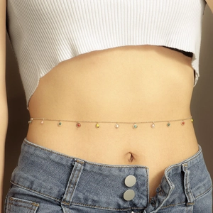 Detailed close-up of a slim gold belly chain featuring vibrant colorful enamel pendants
