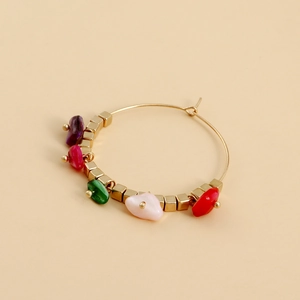 Detail of bohemian gold hoop earring with colorful turquoise and metal square beads
