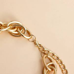 Macro view of gold aluminum chain links featuring polished and textured finishes and lobster clasp