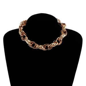 Close-up of polished gold-tone chunky chain link necklace on a black velvet neck model
