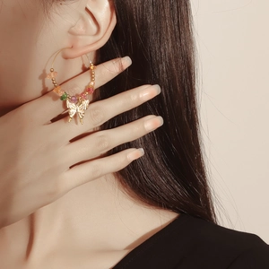 Bohemian large hoop earrings with colorful turquoise beads and a gold butterfly pendant
