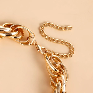 Close-up of golden oversized oval links with a lobster clasp and extension chain