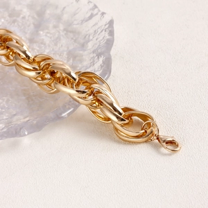 Macro shot of polished gold aluminum chain links featuring a sturdy lobster clasp closure