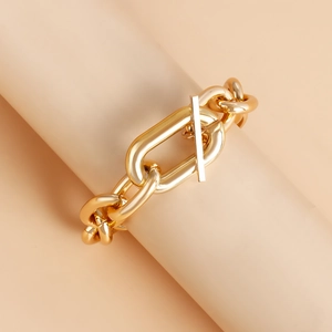 Detailed macro view of the thick golden aluminum chain with decorative toggle OT clasp