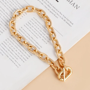 Detailed view of bold gold-tone link chain necklace with a stylish OT toggle clasp