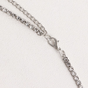 Macro shot of silver rhinestone body chain with lobster clasp and adjustable extension chain