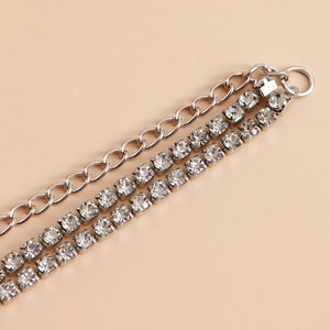 Detail of layered silver body chain with multi-row rhinestone claw setting and O-link chain