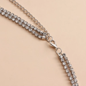 Close-up of layered silver body chain with sparkling rhinestones and lobster clasp