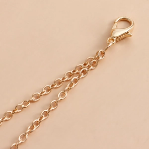 Detail view of the lobster clasp and golden chain for the sexy bikini body chain