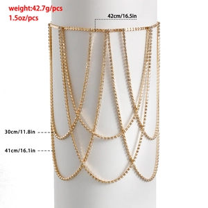 Detailed view of layered gold leg chain with rhinestones and sparkling tassel fringe