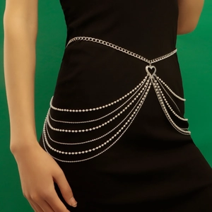 Multi-layer waist chain with faux pearls and heart pendant over black dress