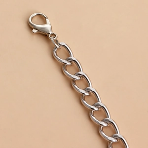 Macro shot of silver lobster clasp and thick oval chain links with 925 hallmark