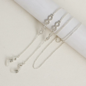 Detail of silver infinity glasses chain with sparkling rhinestones and white silicone loops