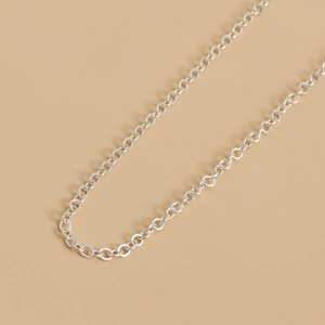 Macro shot of minimalist silver metal chain links with a polished finish for accessories