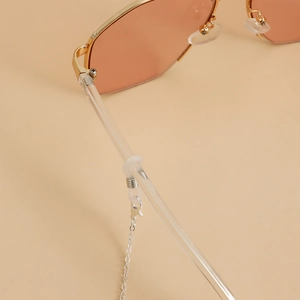 Close-up of diamond infinity charm eyewear chain with orange-pink lenses and gold frame